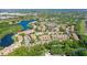 Aerial view of Pinestone community, highlighting its location near a lake and mature trees at 4275 Castlebridge Ln # 1312B1, Sarasota, FL 34238