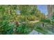 Landscaped backyard with lush tropical plants at 4275 Castlebridge Ln # 1312B1, Sarasota, FL 34238