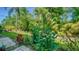 Lush tropical landscaping and paved pathway at 4275 Castlebridge Ln # 1312B1, Sarasota, FL 34238