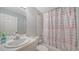 Bathroom with tub, shower, and patterned curtain at 4275 Castlebridge Ln # 1312B1, Sarasota, FL 34238