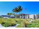 Siesta Beach amenities, including a building and palm trees at 4275 Castlebridge Ln # 1312B1, Sarasota, FL 34238