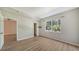 Bright bedroom with wood-look floors and large window at 4275 Castlebridge Ln # 1312B1, Sarasota, FL 34238
