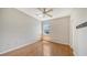 Simple bedroom with wood-look floors and ceiling fan at 4275 Castlebridge Ln # 1312B1, Sarasota, FL 34238