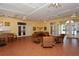 Bright community room with tiled floors, comfortable seating, and access to outdoor areas at 4275 Castlebridge Ln # 1312B1, Sarasota, FL 34238