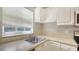 Kitchen features white cabinets, stainless steel sink and countertops at 4275 Castlebridge Ln # 1312B1, Sarasota, FL 34238