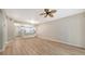 Spacious living room with wood-look floors and ceiling fan at 4275 Castlebridge Ln # 1312B1, Sarasota, FL 34238