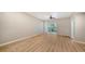 Bright living room with wood-look floors and sliding glass doors at 4275 Castlebridge Ln # 1312B1, Sarasota, FL 34238