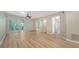 Living room with wood-look floors, sliding doors and access to bathroom at 4275 Castlebridge Ln # 1312B1, Sarasota, FL 34238