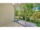 View from patio shows lush tropical landscaping at 4275 Castlebridge Ln # 1312B1, Sarasota, FL 34238