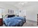 Bright bedroom with a queen bed, neutral decor, and access to a hallway at 4316 12Th Street E Ct, Ellenton, FL 34222