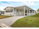 Mobile home with carport, landscaping, and paved driveway at 4316 12Th Street E Ct, Ellenton, FL 34222