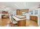 Modern kitchen featuring wood cabinets, island with seating, and a breakfast nook at 4316 12Th Street E Ct, Ellenton, FL 34222