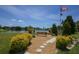Serene lakefront view with a memorial bench and flag at 4316 12Th Street E Ct, Ellenton, FL 34222