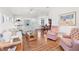 Open living area with hardwood floors, comfy furniture, and views to dining area at 4316 12Th Street E Ct, Ellenton, FL 34222