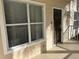 Exterior entryway with brown door, window, and light beige siding at 4802 51St W St # 708, Bradenton, FL 34210