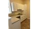 White kitchen cabinets, light countertops, and stainless steel dishwasher at 4802 51St W St # 708, Bradenton, FL 34210