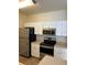 Modern kitchen with white cabinets, stainless steel appliances, and light countertops at 4802 51St W St # 708, Bradenton, FL 34210