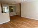 Spacious living room with light wood laminate flooring and large mirror at 4802 51St W St # 708, Bradenton, FL 34210