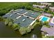Community tennis courts and pool from above at 4892 Peregrine E Pt, Sarasota, FL 34231
