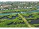 Aerial view showing neighborhood, waterway, and lush mangrove landscape at 4892 Peregrine E Pt, Sarasota, FL 34231