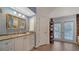 Bathroom with granite countertop, updated vanity, and pool access at 4892 Peregrine E Pt, Sarasota, FL 34231