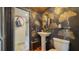 Stylish powder room with pedestal sink and unique wallpaper at 4892 Peregrine E Pt, Sarasota, FL 34231