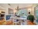Charming dining room with white table and chairs, bay window and chandelier at 4892 Peregrine E Pt, Sarasota, FL 34231