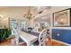 Bright dining area with white table, chandelier, and view into the living room at 4892 Peregrine E Pt, Sarasota, FL 34231