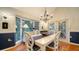 Elegant dining room with white table, chairs, and a view of the backyard at 4892 Peregrine E Pt, Sarasota, FL 34231