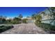 Long driveway with brick pavers and tropical landscaping at 4892 Peregrine E Pt, Sarasota, FL 34231