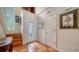 Front entry with terracotta tile floors, wooden staircase, and stained glass door at 4892 Peregrine E Pt, Sarasota, FL 34231