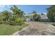 Two-story house with light blue brick exterior, landscaping, and paver driveway at 4892 Peregrine E Pt, Sarasota, FL 34231