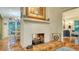White brick fireplace with gas logs, located between dining and kitchen areas at 4892 Peregrine E Pt, Sarasota, FL 34231