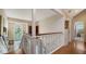 Upstairs hallway with hardwood floors and white railing at 4892 Peregrine E Pt, Sarasota, FL 34231