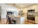 Modern kitchen with granite island, stainless steel appliances, and white cabinets at 4892 Peregrine E Pt, Sarasota, FL 34231