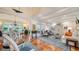 Open living and dining area with terracotta floors, blue accents, and access to pool at 4892 Peregrine E Pt, Sarasota, FL 34231