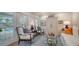 Living area with white sofas, blue rug and french doors leading to pool at 4892 Peregrine E Pt, Sarasota, FL 34231
