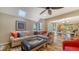 Living room with sectional sofa, hardwood floors, and skylights at 4892 Peregrine E Pt, Sarasota, FL 34231
