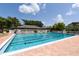 Inviting community swimming pool with lounge chairs at 4892 Peregrine E Pt, Sarasota, FL 34231
