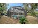 Screened-in pool with surrounding landscaping and pavers at 4892 Peregrine E Pt, Sarasota, FL 34231