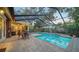 Enclosed pool area with brick pavers, and covered patio at 4892 Peregrine E Pt, Sarasota, FL 34231