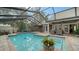 Inviting swimming pool with screened enclosure and brick pavers at 4892 Peregrine E Pt, Sarasota, FL 34231