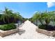 Walkway leading to well-maintained community tennis courts at 4892 Peregrine E Pt, Sarasota, FL 34231