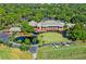 Aerial view of clubhouse, golf course, and driving range at 5152 Marsh Field Ln # 117, Sarasota, FL 34235