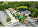 Aerial view of community clubhouse, parking, and pond at 5152 Marsh Field Ln # 117, Sarasota, FL 34235