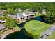 Aerial view of clubhouse with golf course and pond at 5152 Marsh Field Ln # 117, Sarasota, FL 34235