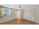 Bedroom featuring wood-look floors and built-in closet at 5152 Marsh Field Ln # 117, Sarasota, FL 34235