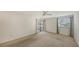 Bedroom with carpet, sliding glass doors, and window coverings at 5152 Marsh Field Ln # 117, Sarasota, FL 34235