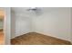 Bedroom with wood-look flooring and louvered closet doors at 5152 Marsh Field Ln # 117, Sarasota, FL 34235