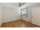Spacious bedroom with wood-look flooring and window at 5152 Marsh Field Ln # 117, Sarasota, FL 34235